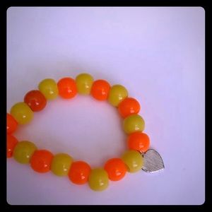 Orange and yellow bracelet with striped heart carm